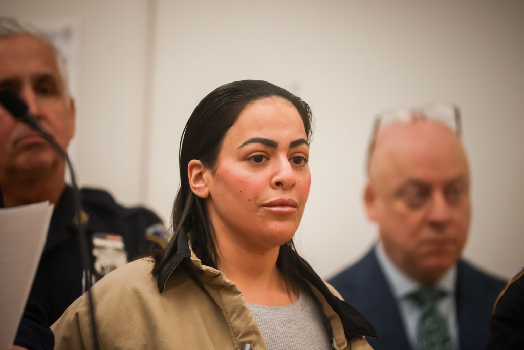 A photo of Yarimi in court, donning a beige prison uniform. 