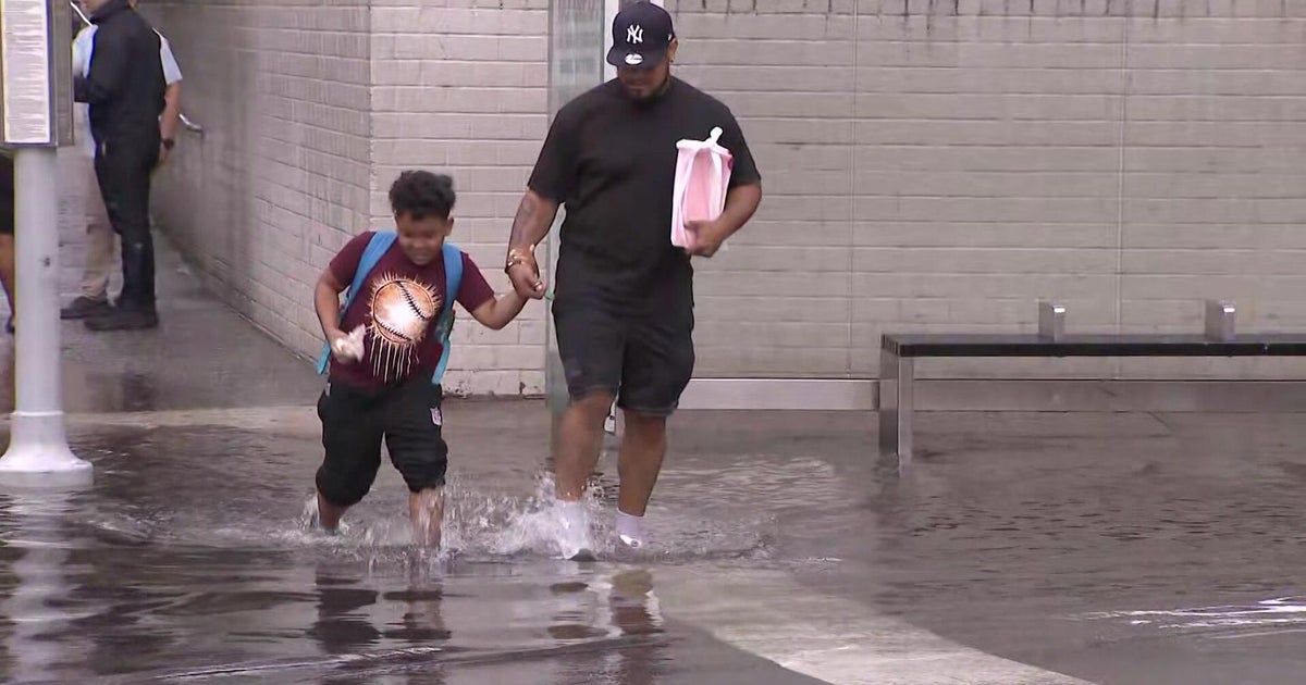 New Yorkers wade through ankle-deep water during flash flood in Brooklyn