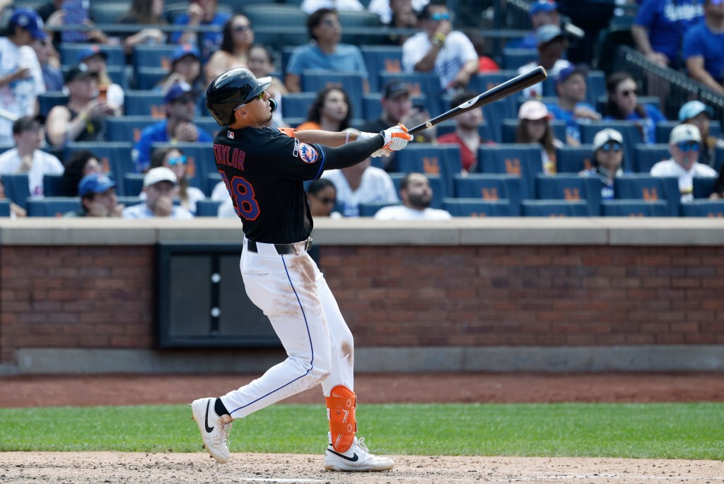 New York Mets center fielder Tyrone Taylor hitting a three-run home run.