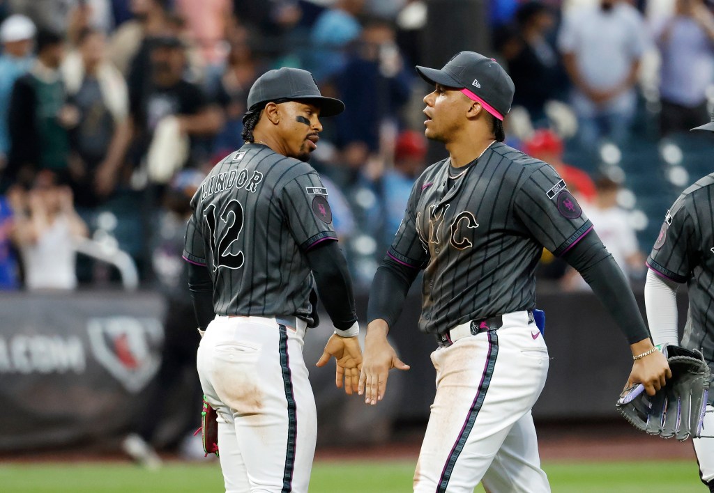 New York Mets shortstop Francisco Lindor (12) celebrates with New York Mets left fielder Juan Soto (22) after the final out of the 9th inning.