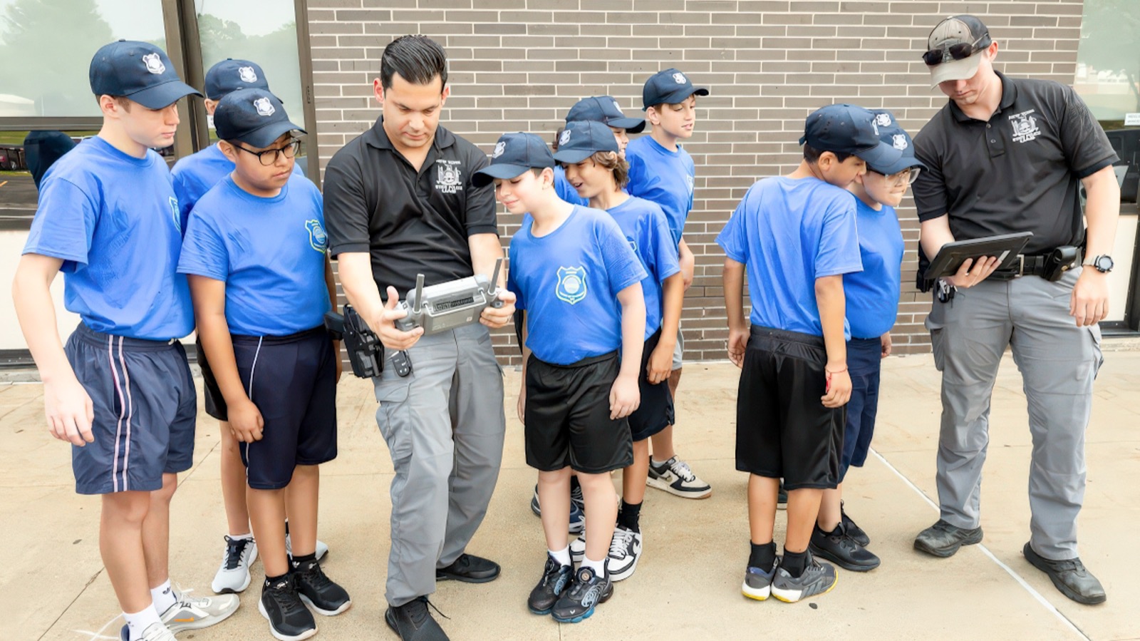 Warwick Junior Police Academy cadets watching a State Police drone demonstration