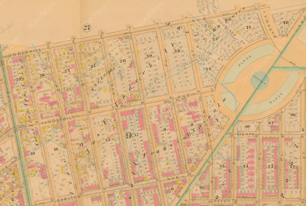 Historical map showing streets, buildings, and landmarks in a city layout, featuring detailed annotations and color coding.