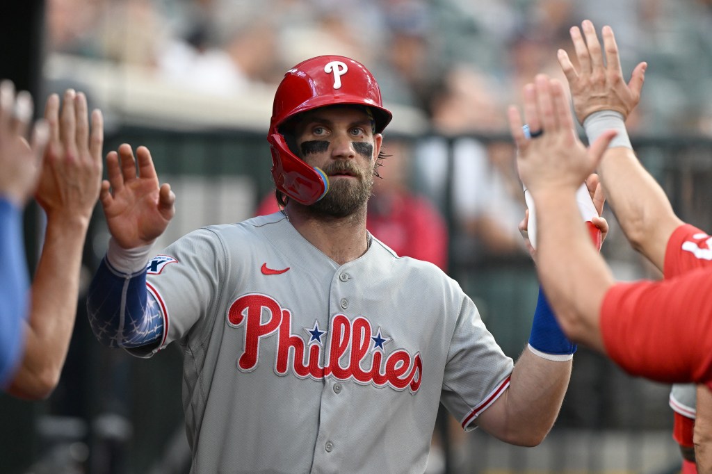 Philadelphia Phillies first baseman Bryce Harper celebrates in the dugout after scoring a run against the Detroit Tigers.