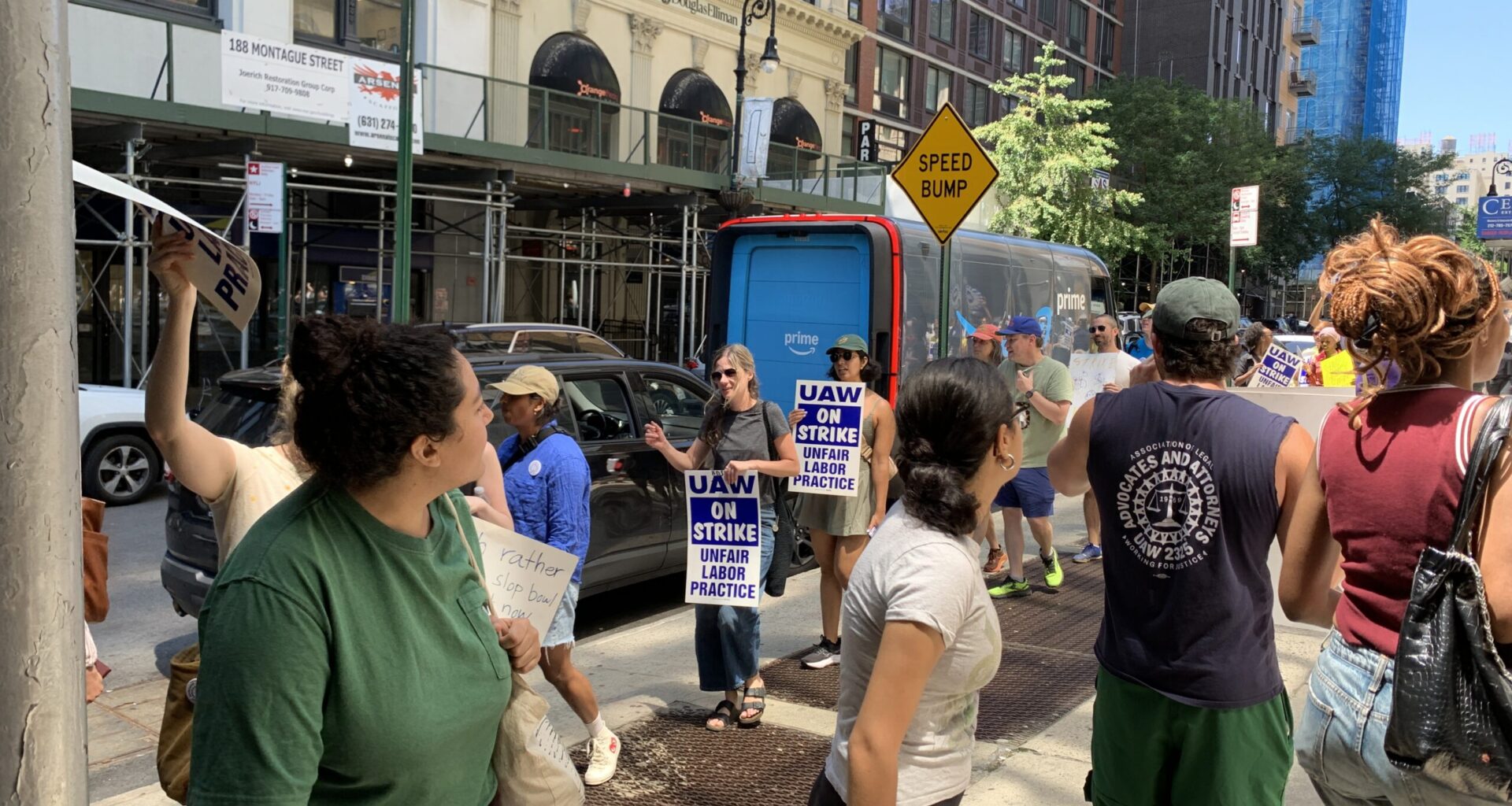 Picketers outside 195 Montague St. held signs and chanted in support of the union’s demands. Photo: Agatha Scaggiante/Brooklyn Eagle