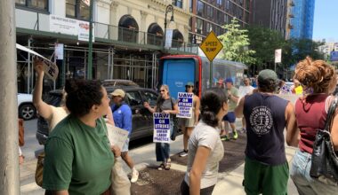 Picketers outside 195 Montague St. held signs and chanted in support of the union’s demands. Photo: Agatha Scaggiante/Brooklyn Eagle