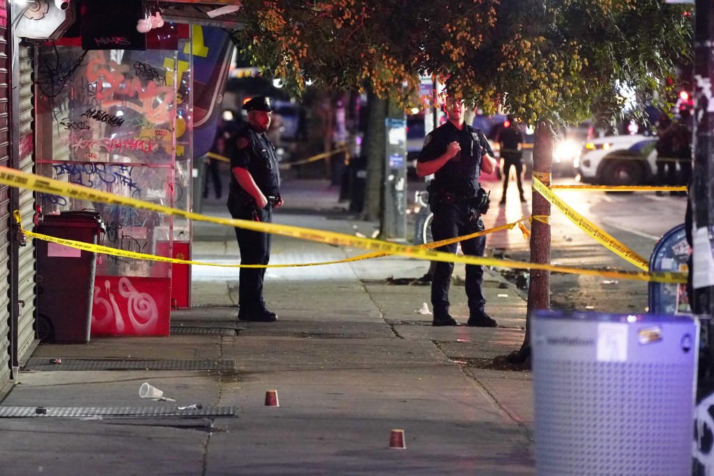 Police officers at the scene where an NYPD officer was shot on Nostrand Avenue at St. Johns Place in Brooklyn.