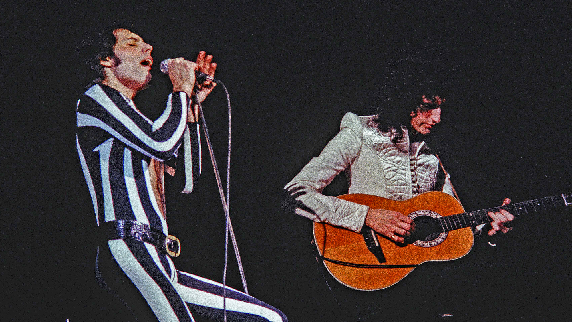 Freddie Mercury and Brian May of Queen perform live at The Oakland Coliseum in 1977 in Oakland, California.