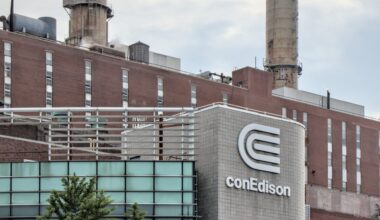 The conEdison building features a prominent logo, with industrial structures and smokestacks in the background.