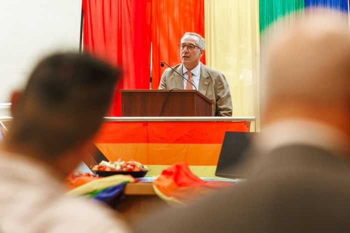 man in a suit stading at podium
