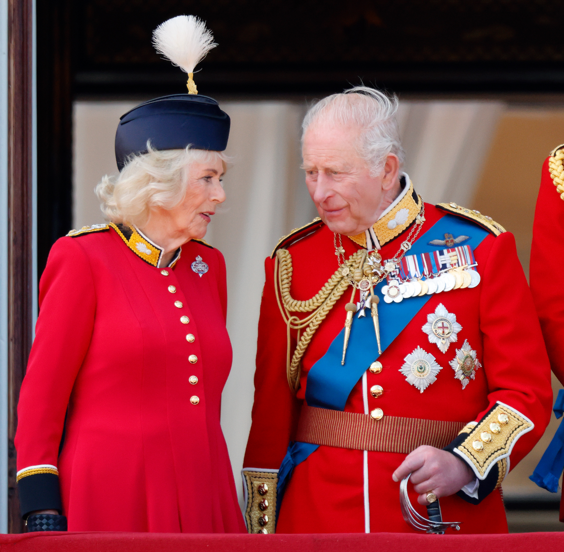 Queen Camilla and King Charles talking to each other at Trooping the Colour 2026
