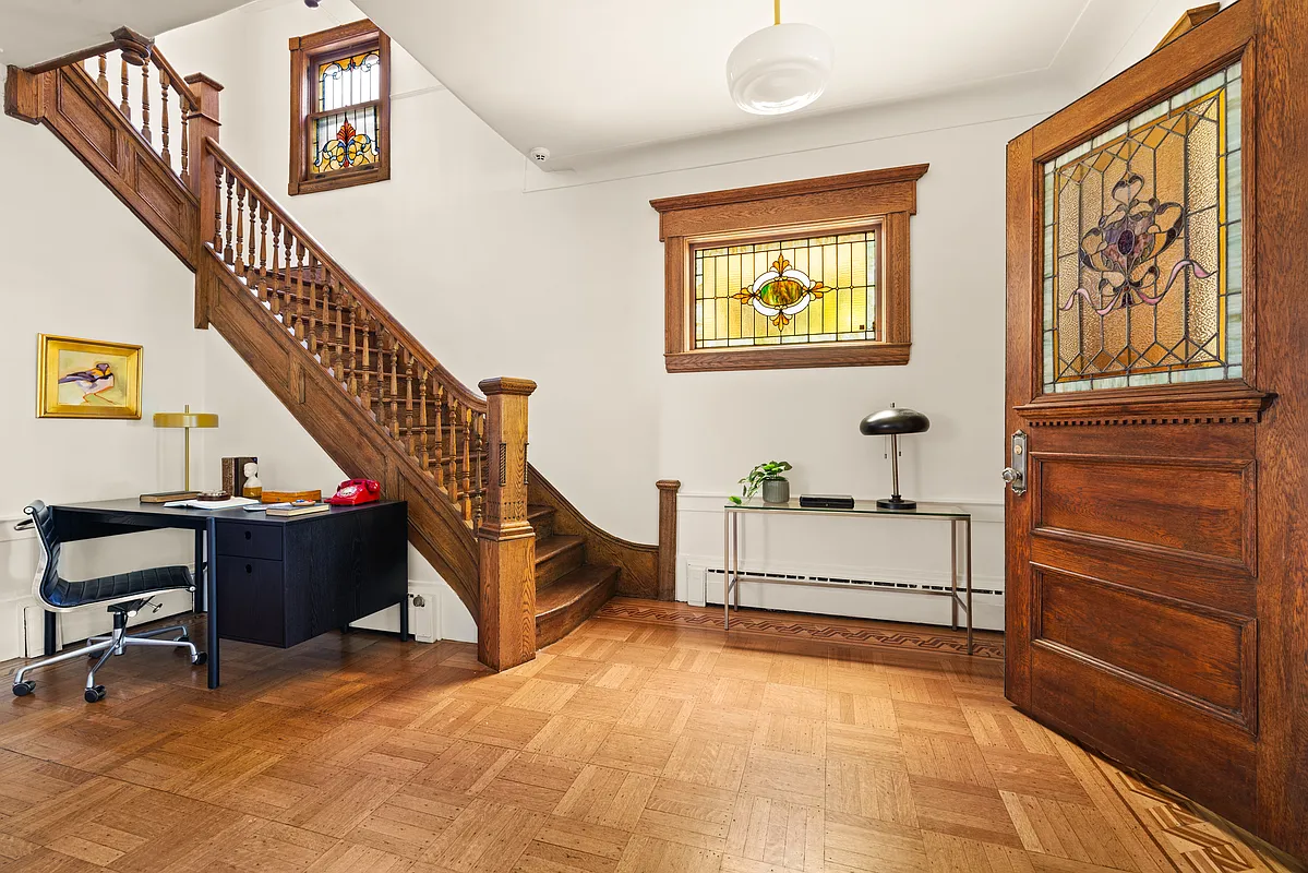front entry with stained glass windows, wood floor, stair