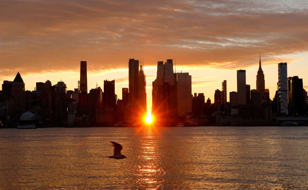Manhattanhenge sunrise over the midtown skyline as seen from Weehawken, New Jersey.