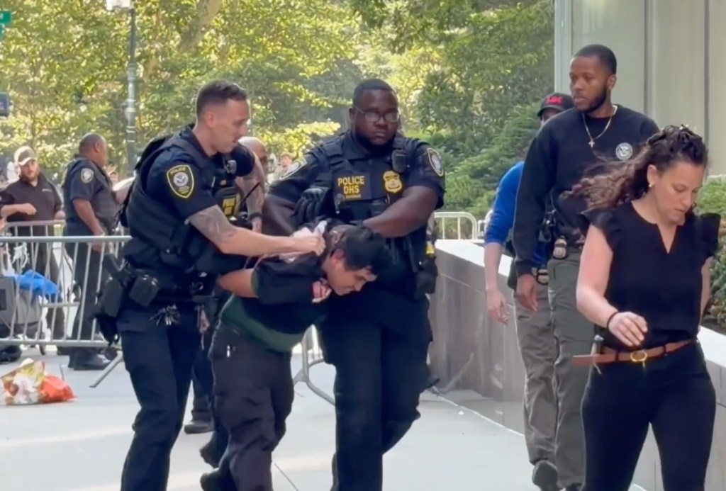 Suspect being taken into custody by police officers.
