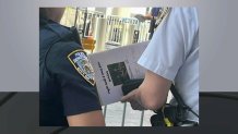 News 4 captured a photo of an NYPD officer wielding a 'Taylor Swift' wedding folder outside MSG.