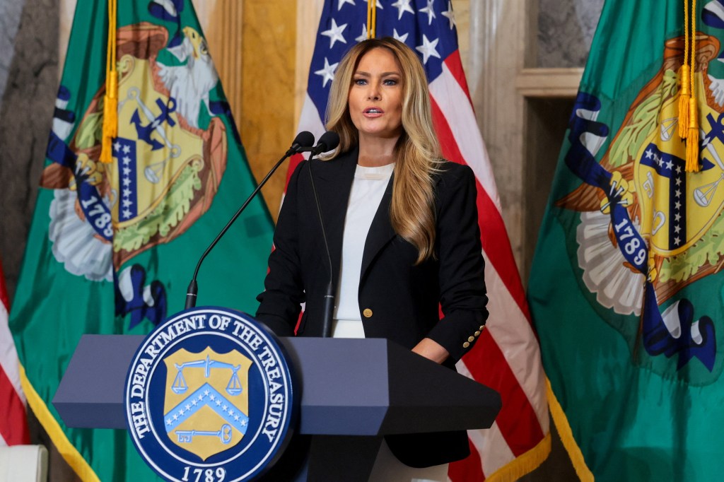Melania Trump speaks at a podium with the seal of the Department of the Treasury.