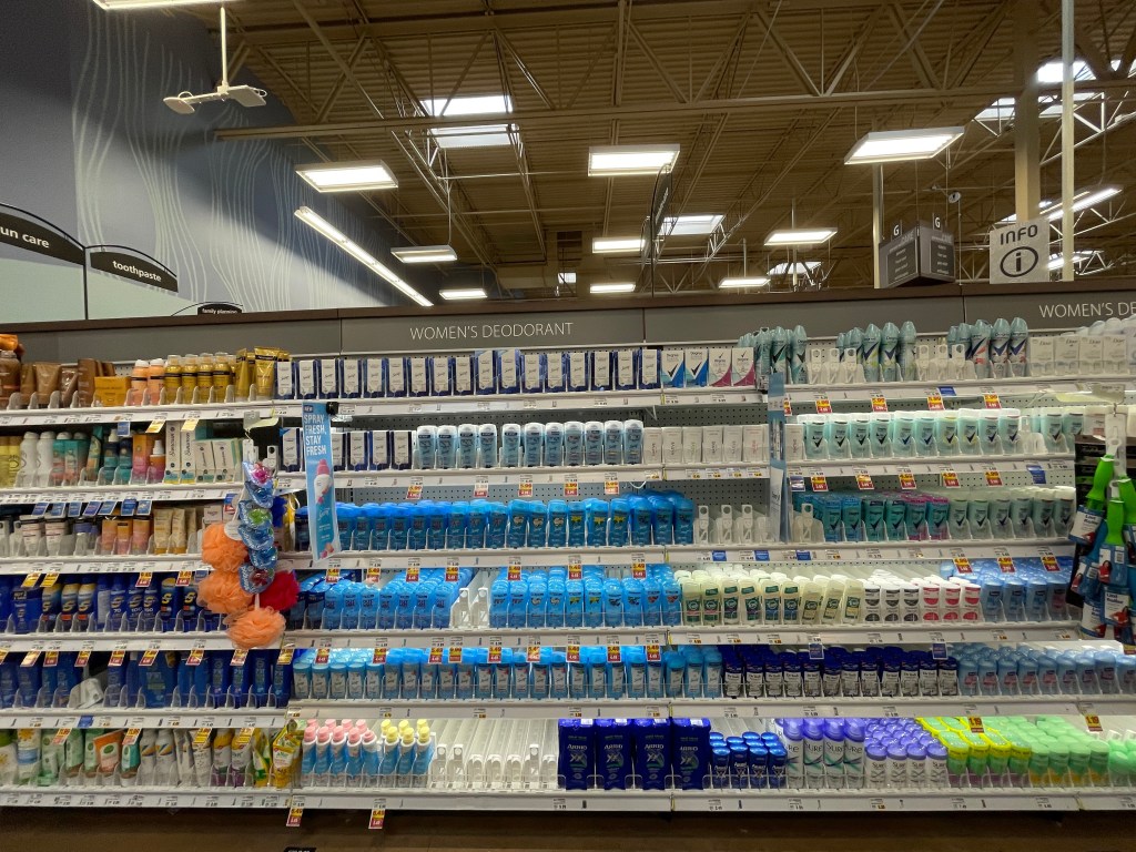 An aisle in Walmart with shelves full of women's deodorant.