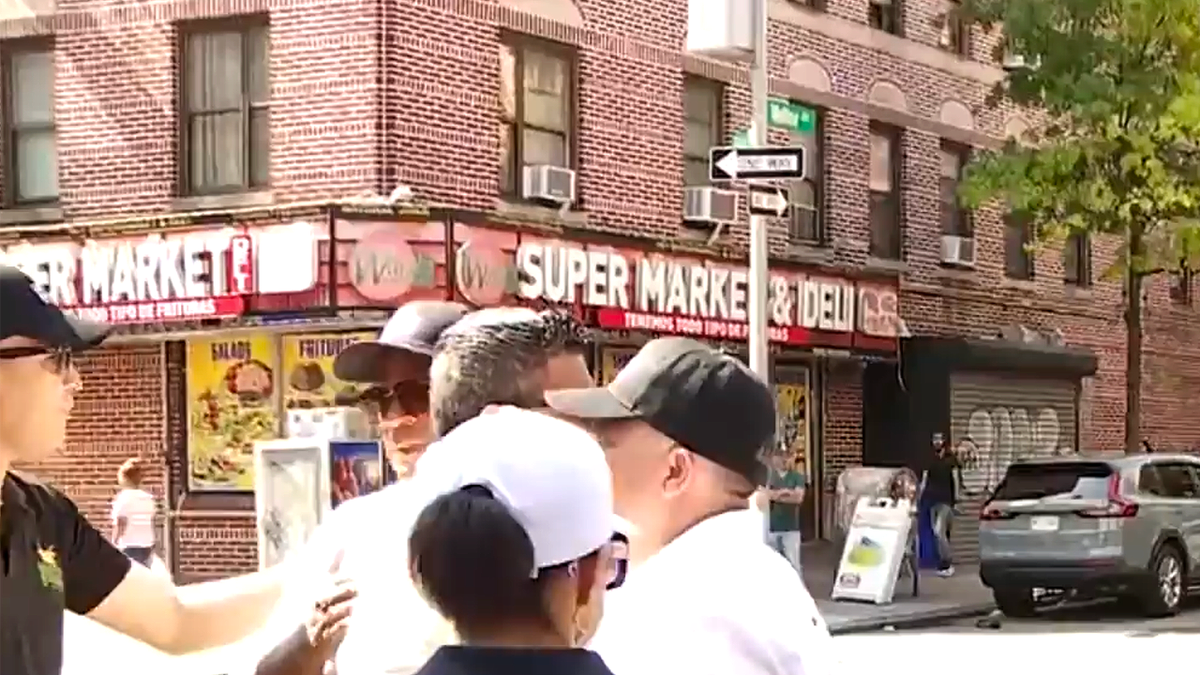 Community members gather outside Wanda Super Market & Deli in the Bronx following the fatal shooting of 12-year-old Jacob Freytes