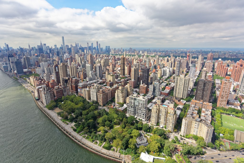 Aerial view of Yorkville and Upper East Side, Manhattan, with the East River and FDR Drive, looking southwest towards Central Park and the Midtown skyline.