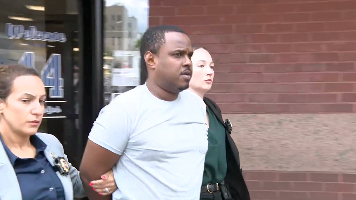 William Ferrer is escorted by NYPD detectives following his arrest in the fatal Bronx shooting of 12-year-old Jacob Freytes