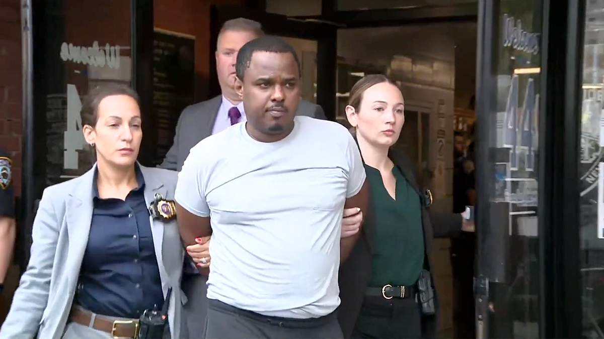William Ferrer is escorted from an NYPD facility after being charged in the fatal Bronx shooting of 12-year-old Jacob Freytes