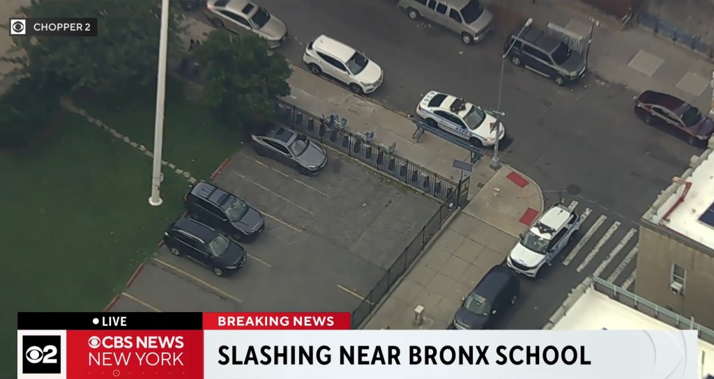 Aerial view of the William Taft High School in the Bronx with a police car parked outside the building.