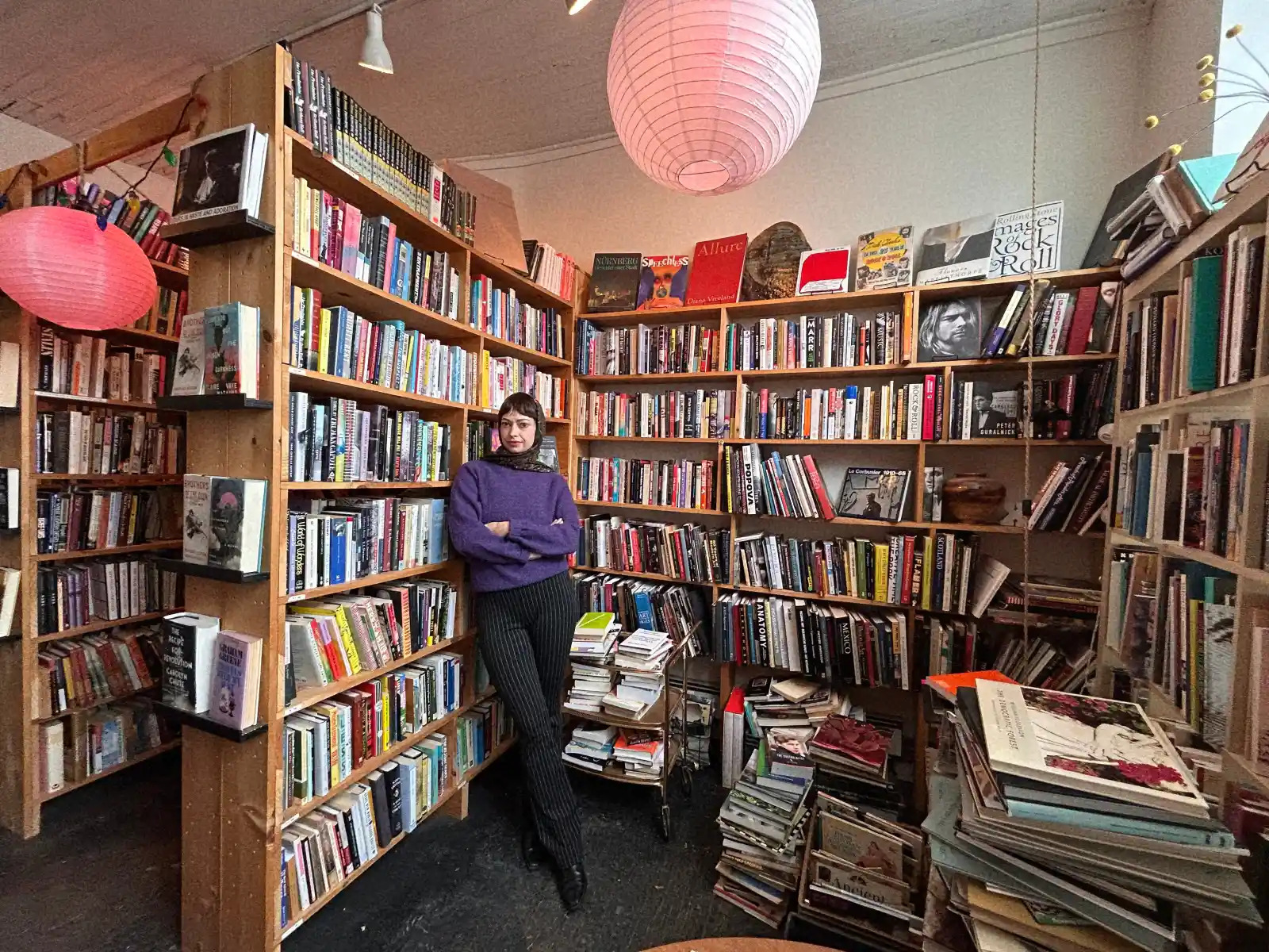 bookshelves with book store owner in foreground