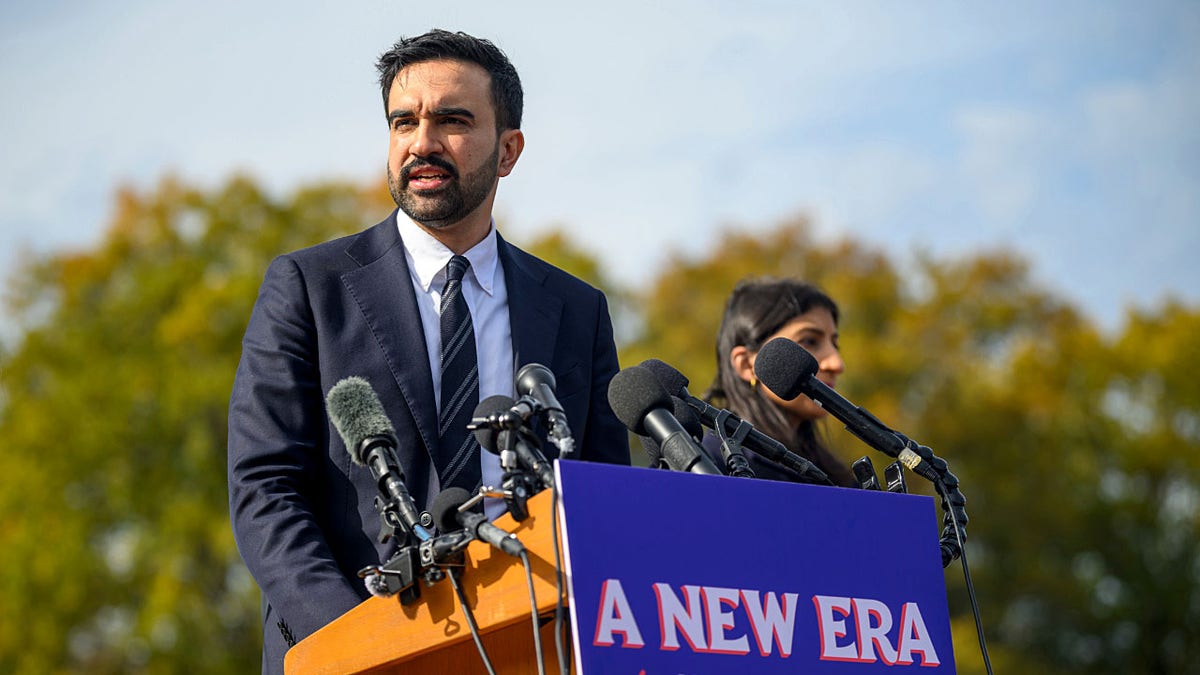 Zohran Mamdani speaking at podium