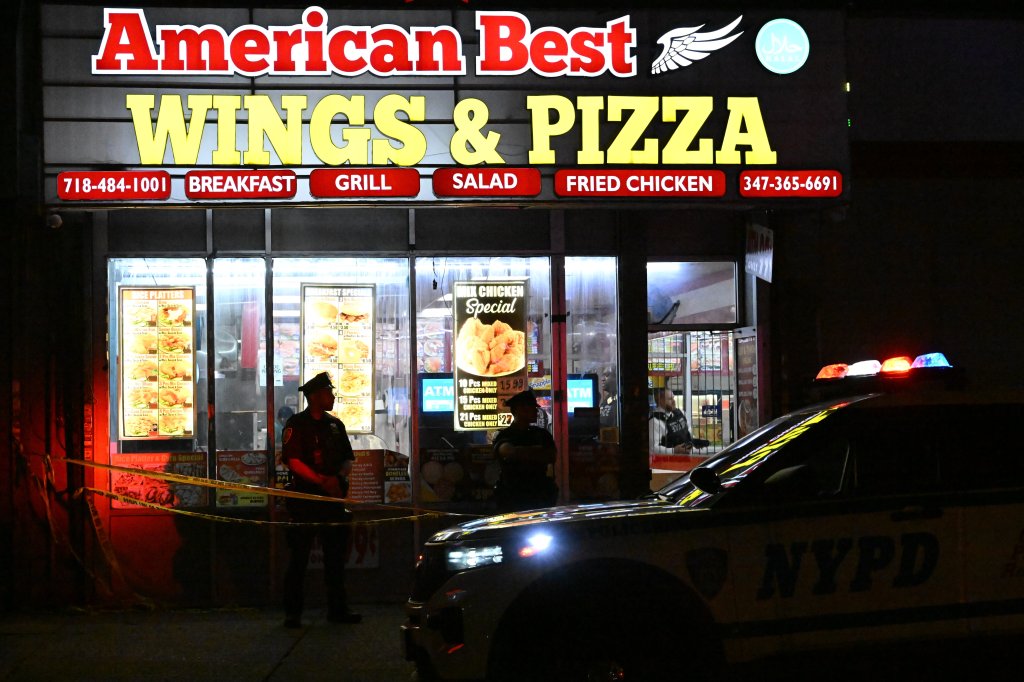 NYPD officers at the scene of a shooting outside American Best Wings & Pizza in Brooklyn, New York.