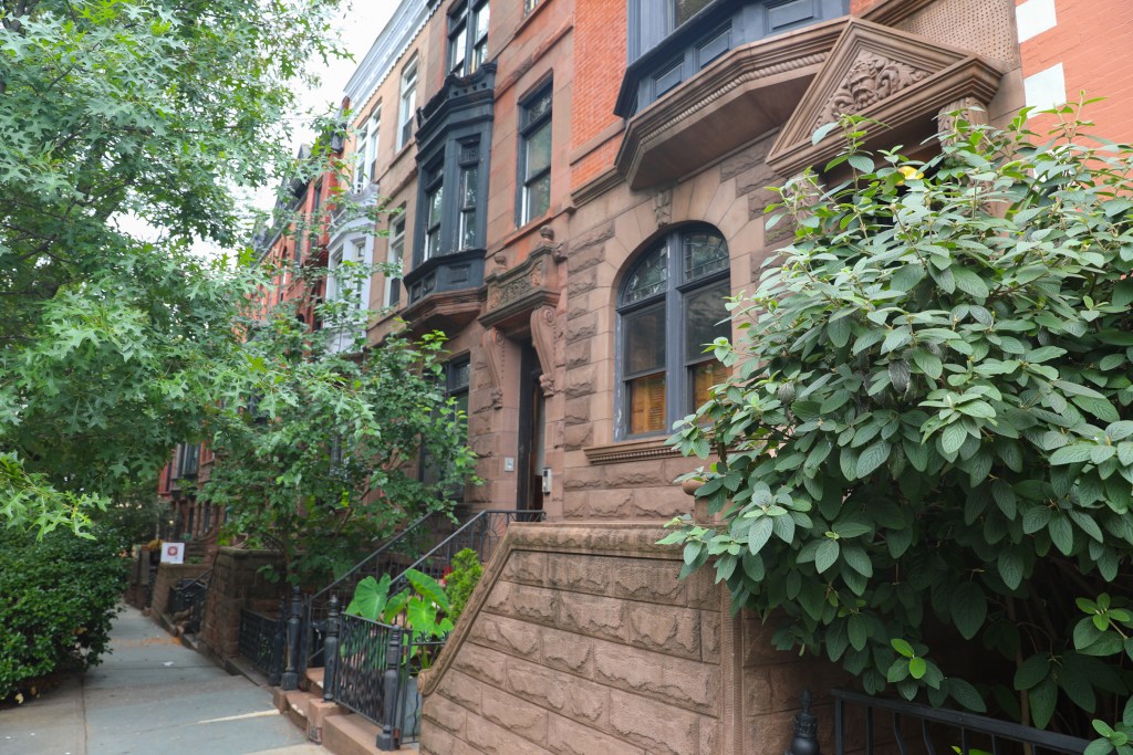 Brownstones line a leafy Upper West Side residential block.