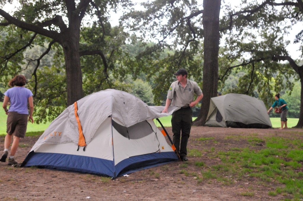 People setting up tents for camping in Prospect Park.