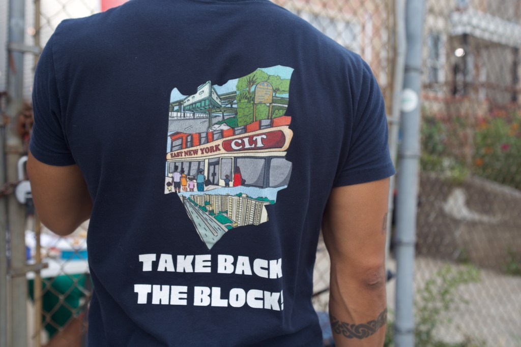 East New York Community Land Trust President Boris Santos shows off the nonprofit’s merchandise during an event at the East Brooklyn Liberation Center,