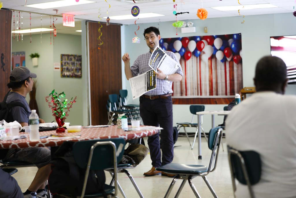 MTA official Charley Cohen gives a presentation at a Harlem senior center about using OMNY cards