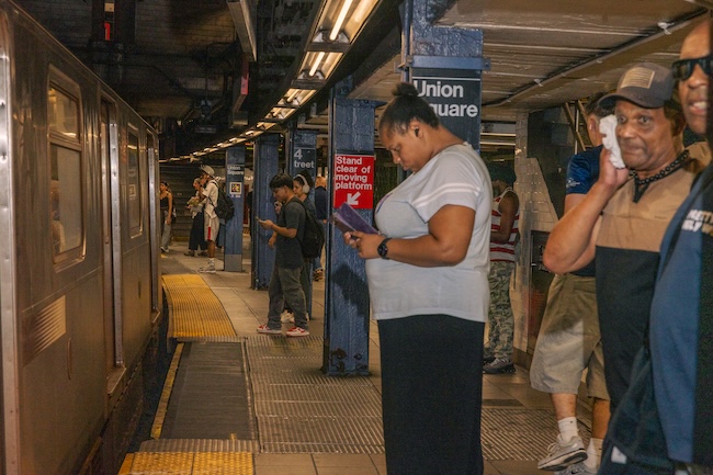 People on the 14th St. Union Square subway station platform