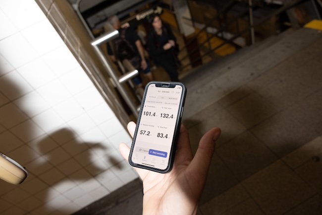 A cell phone showing high measured temperatures in the New York subway.