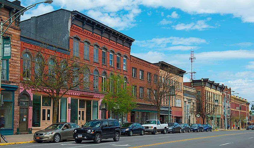 Historic sandstone and brick commercial buildings with Italianate style on Market Street at Main Street in downtown Potsdam, Upstate New York NY, USA. 