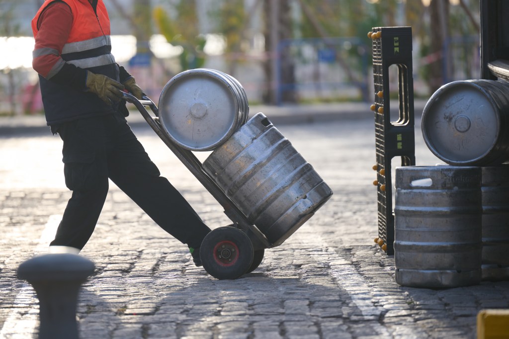 A man delivering a keg into a bar (stock image).