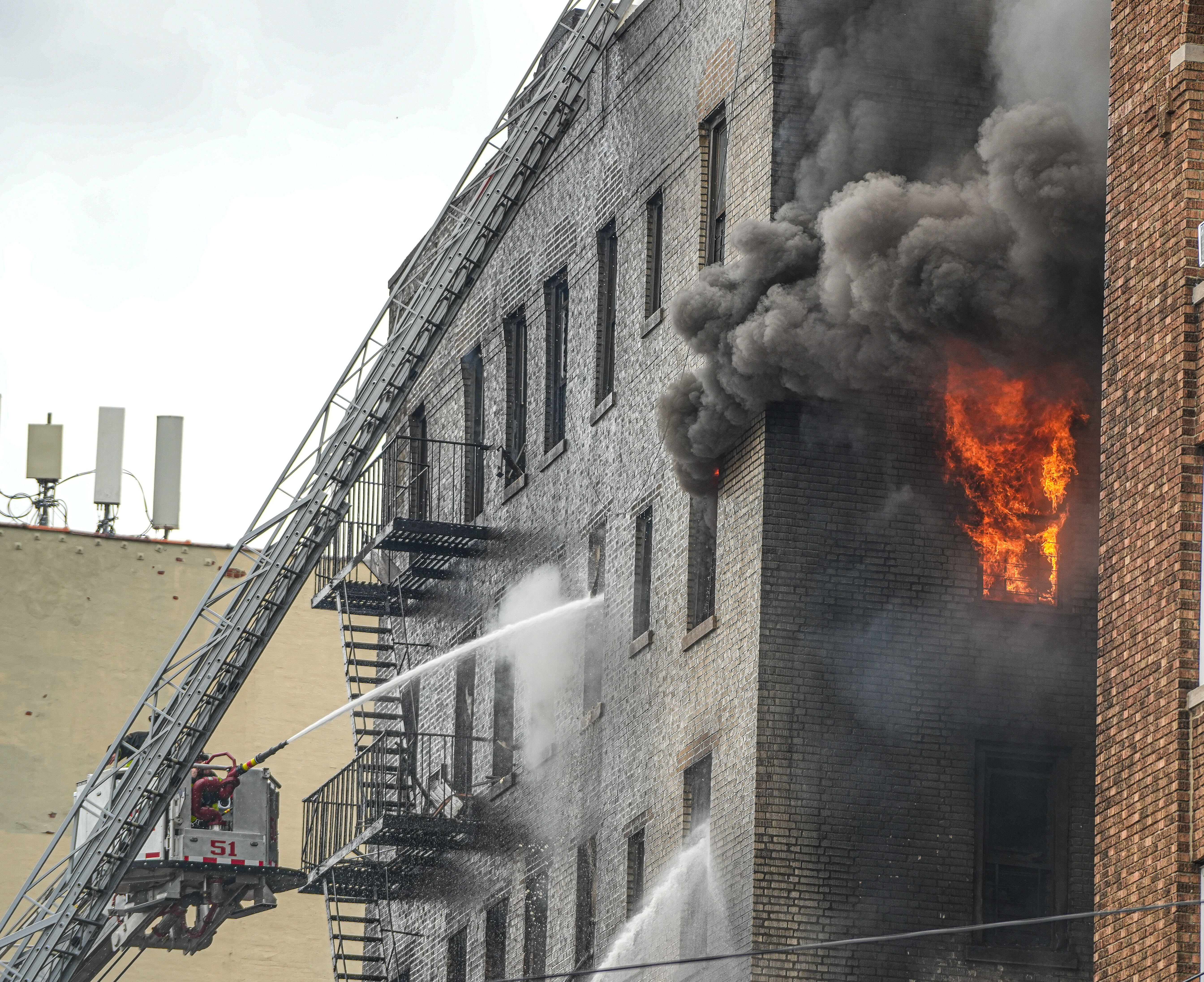 flames and smoke pour from bronx building after explosion
