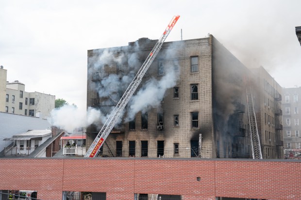 FDNY firefighters work the scene during a massive Bronx fire in a five-story apartment building on E. 209th St. near Parkside Place in the Bronx on Wednesday, Aug. 5, 2026.. (Barry Williams/ New York Daily News)
