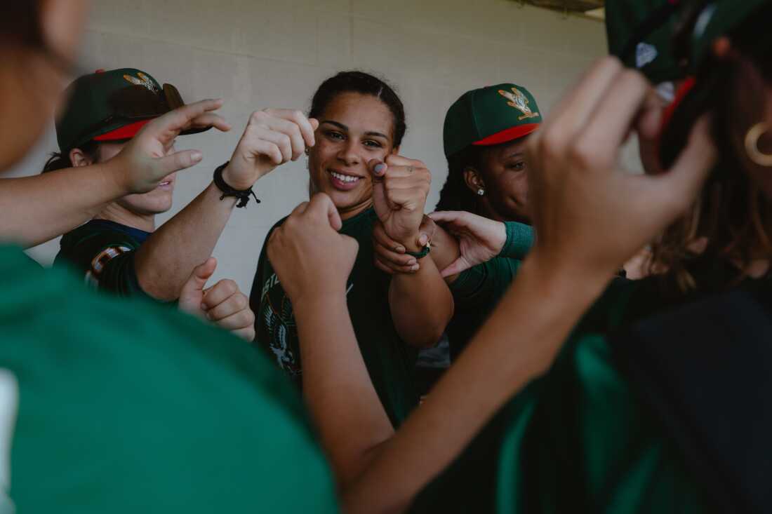 Sabrina Robinson (center) fist bumps her Boston Hunters teammates at the conclusion of a preseaon scrimmage prior to Opening Weekend of the Women's Pro Baseball League. Springfield, IL, July 30, 2026.