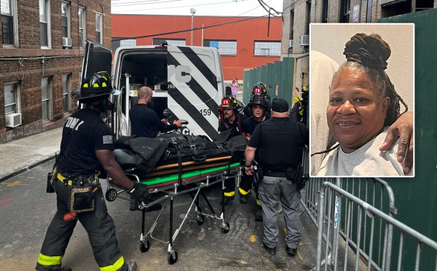 FDNY firefighters remove a body Friday from the Bronx apartment building destroyed by a fire that heartbroken family members believe is missing woman, Mary Anne Martin (inset). (Julian Roberts-Grmela / New York Daily News; Courtesy Family Photo)