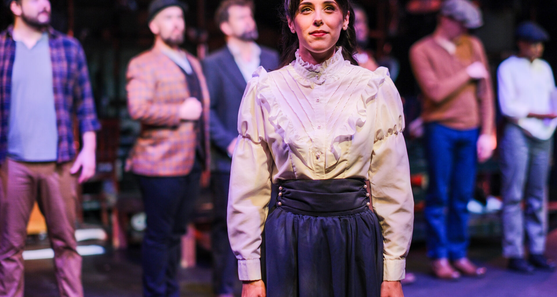 actor attired as Emily Roebling on stage