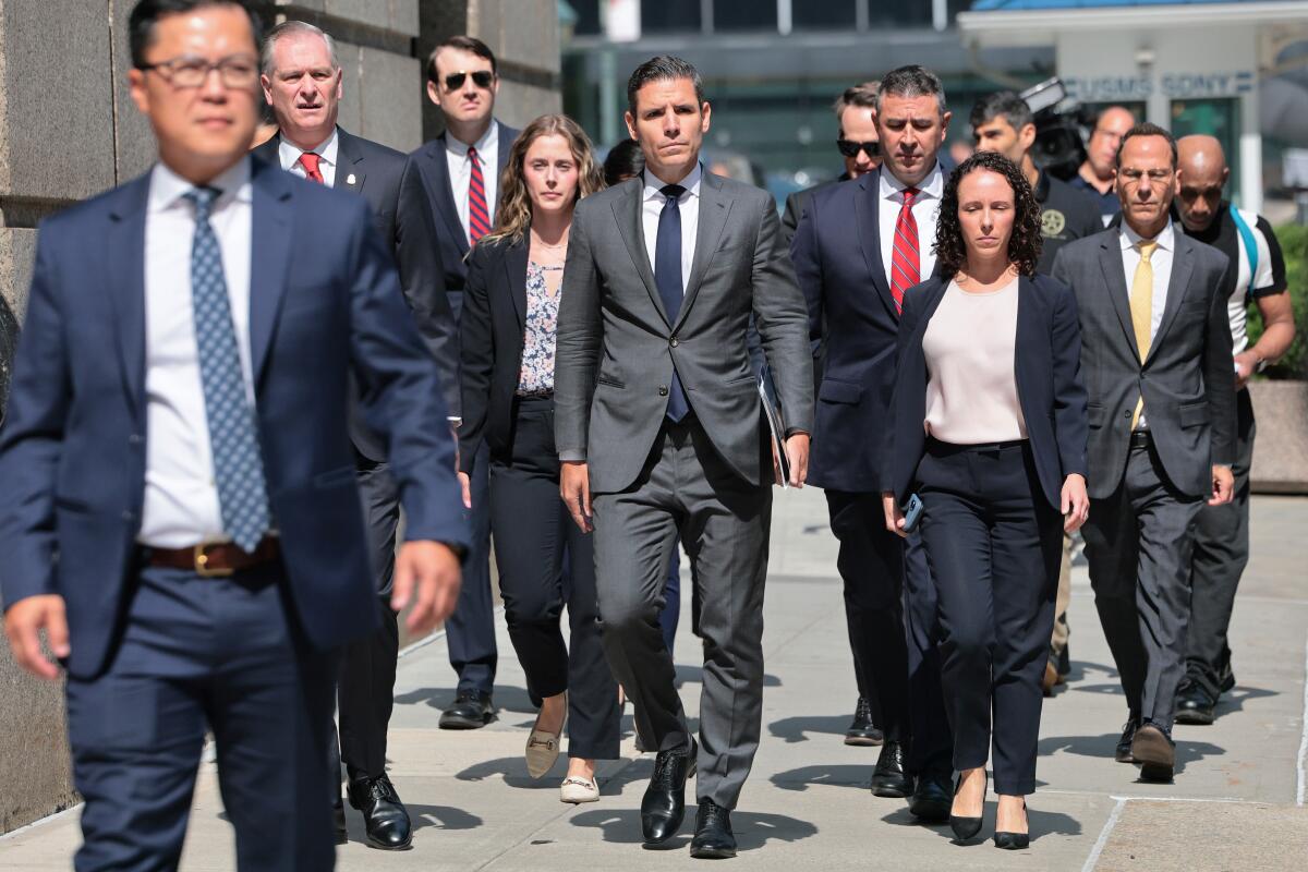 Members of the Department of Justice arrive for a court hearing
