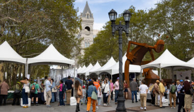 book booths with white tent tops around columbus park with the post office in the background