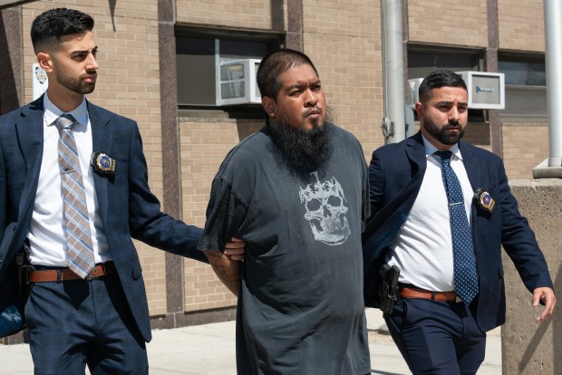 Adrian Benitez, 29, is pictured in police custody leaving the NYPD's 72nd Precinct stationhouse in Brooklyn on Tuesday, Aug. 25, 2026. (Gardiner Anderson / New York Daily News)