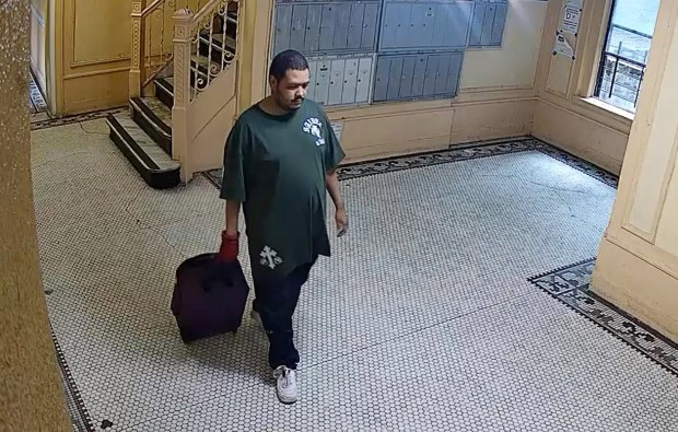 Police released this image of Bob Johnny Guzman Soto leaving the Grand Concourse building wheeling a small suitcase.