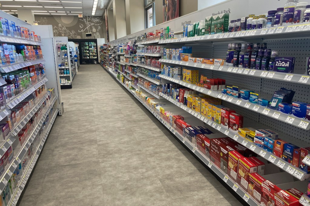 A Walgreens store aisle with limited displayed items and bare shelves.