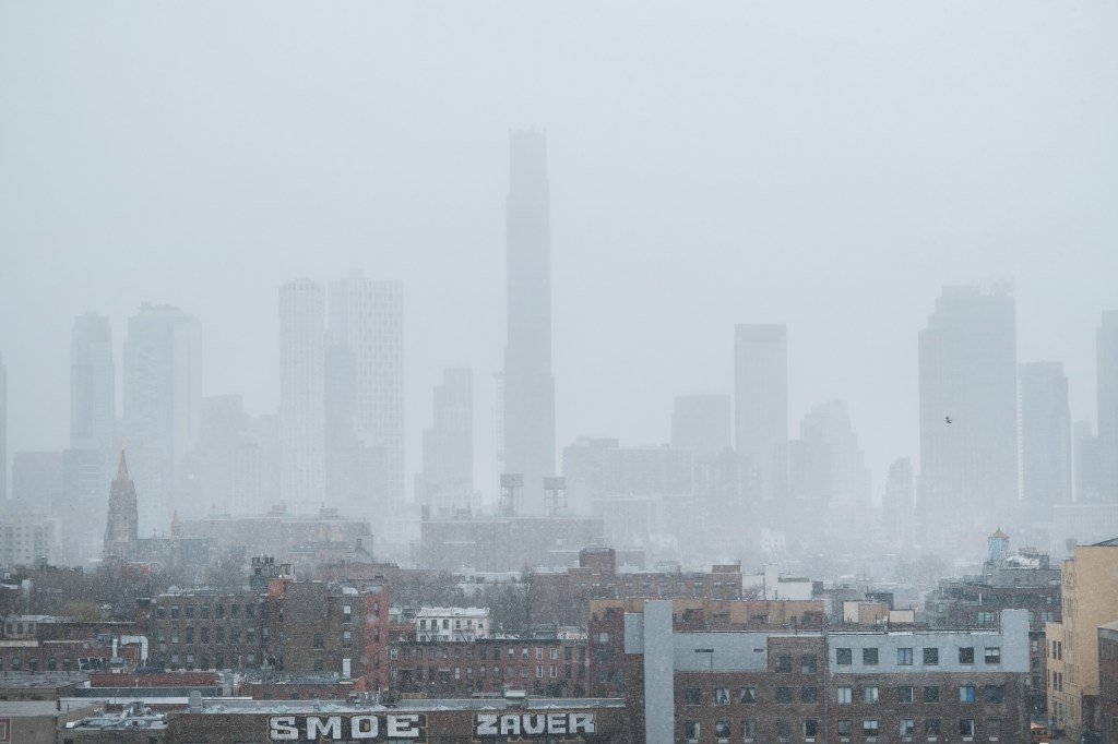 The Brooklyn skyline shrouded in snow during a late winter storm.