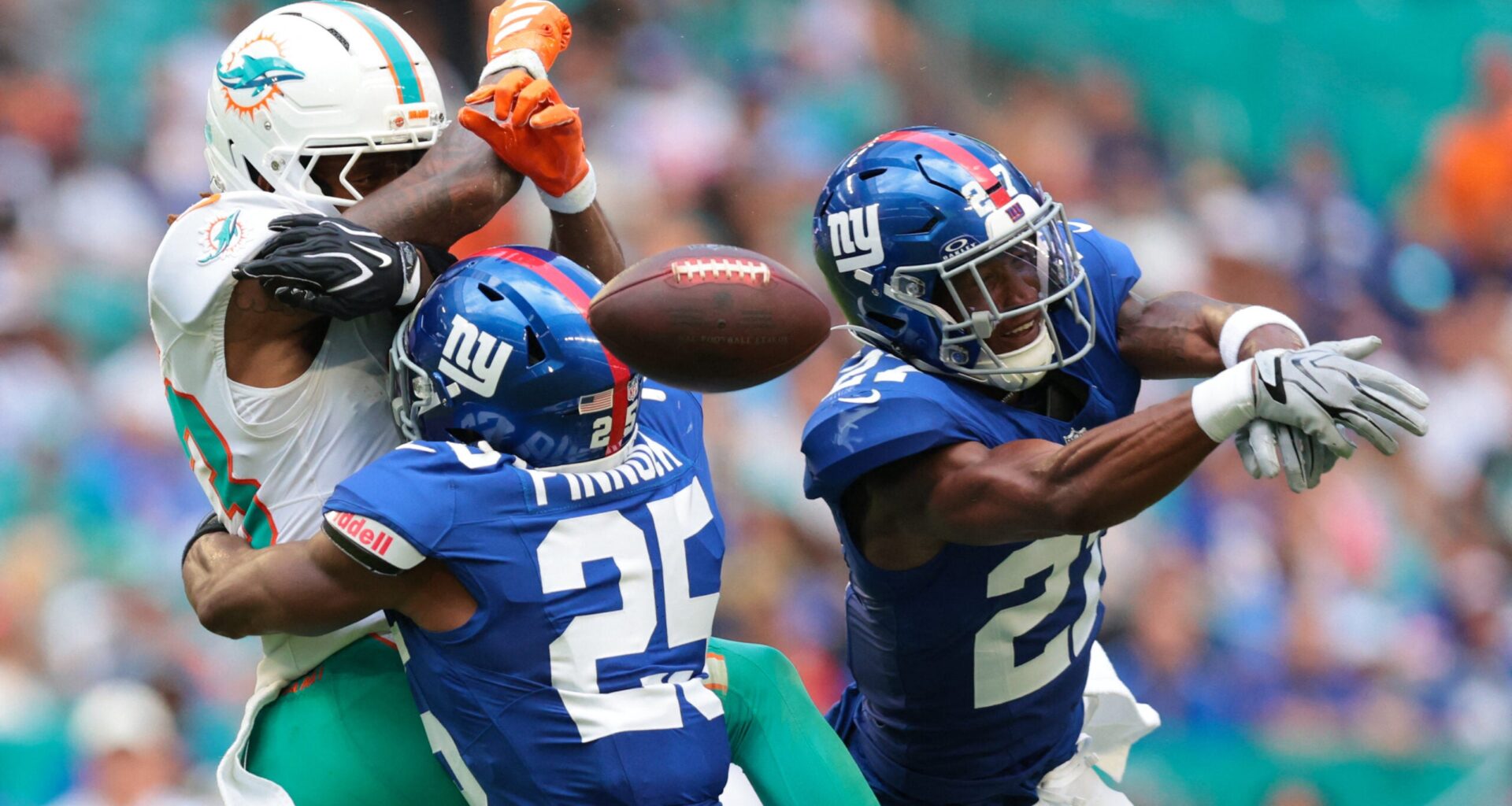 Aug 22, 2026; Miami Gardens, Florida, USA; New York Giants safety Tyler Nubin (27) and safety Jason Pinnock (25) defend against Miami Dolphins wide receiver Kevin Coleman Jr. (83) during the first half at Hard Rock Stadium.