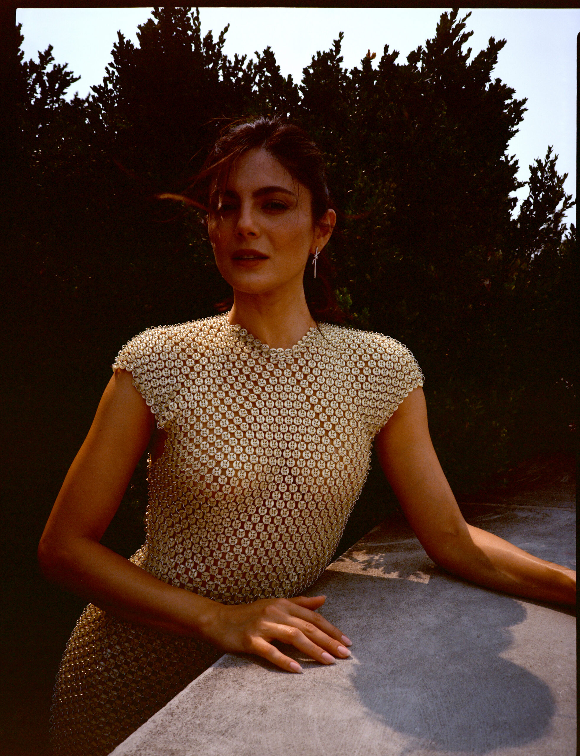 Monica Barbaro in a gold metal dress