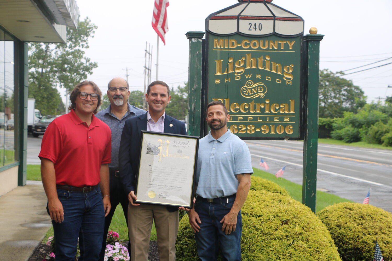 Assemblyman Slater presents the owners of Mid-Hudson Electric with a proclamation naming them to the New York State Historic Business Preservation Registry,